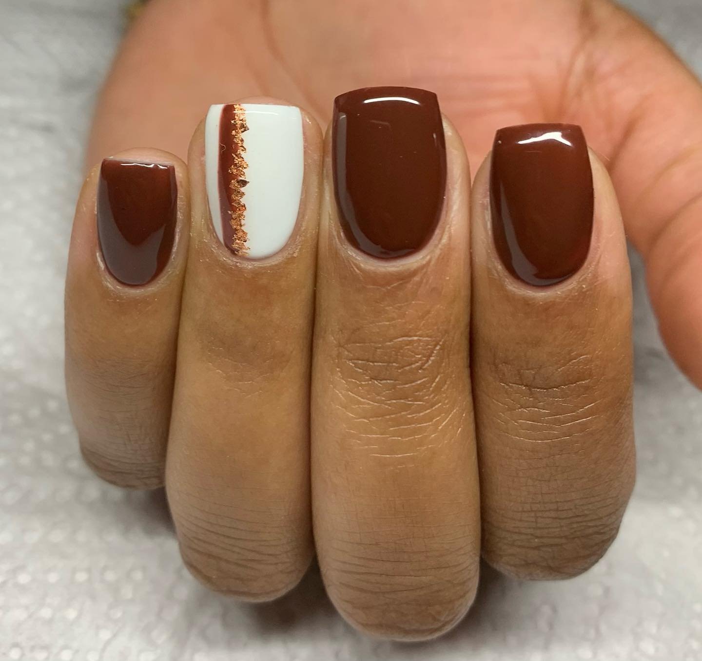 Short Brown Nails with a Single White and Gold Stripe Accent