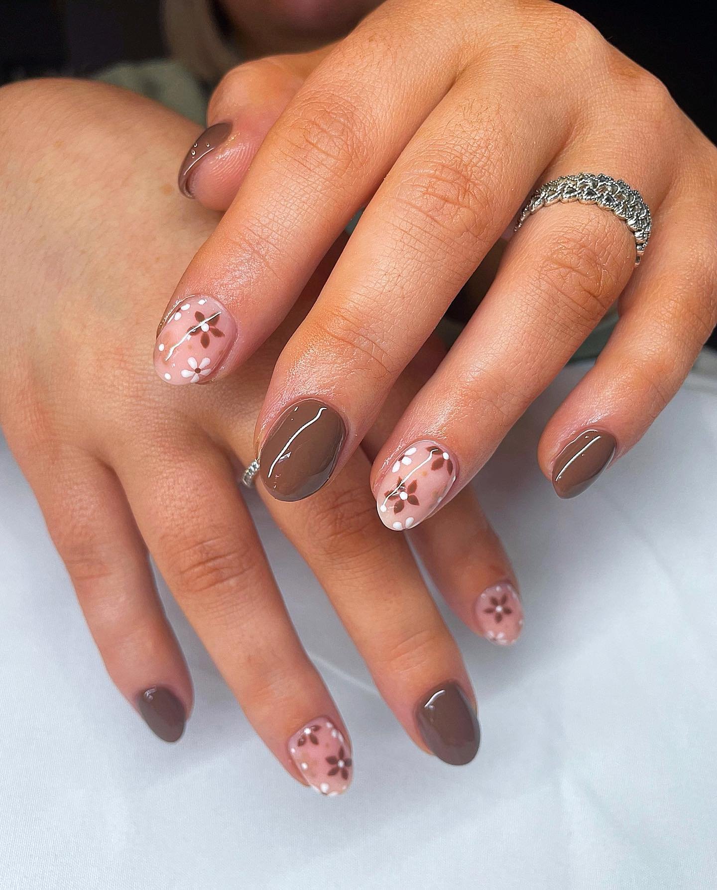 Short Brown Nails with Pink Floral-Like Accent Details