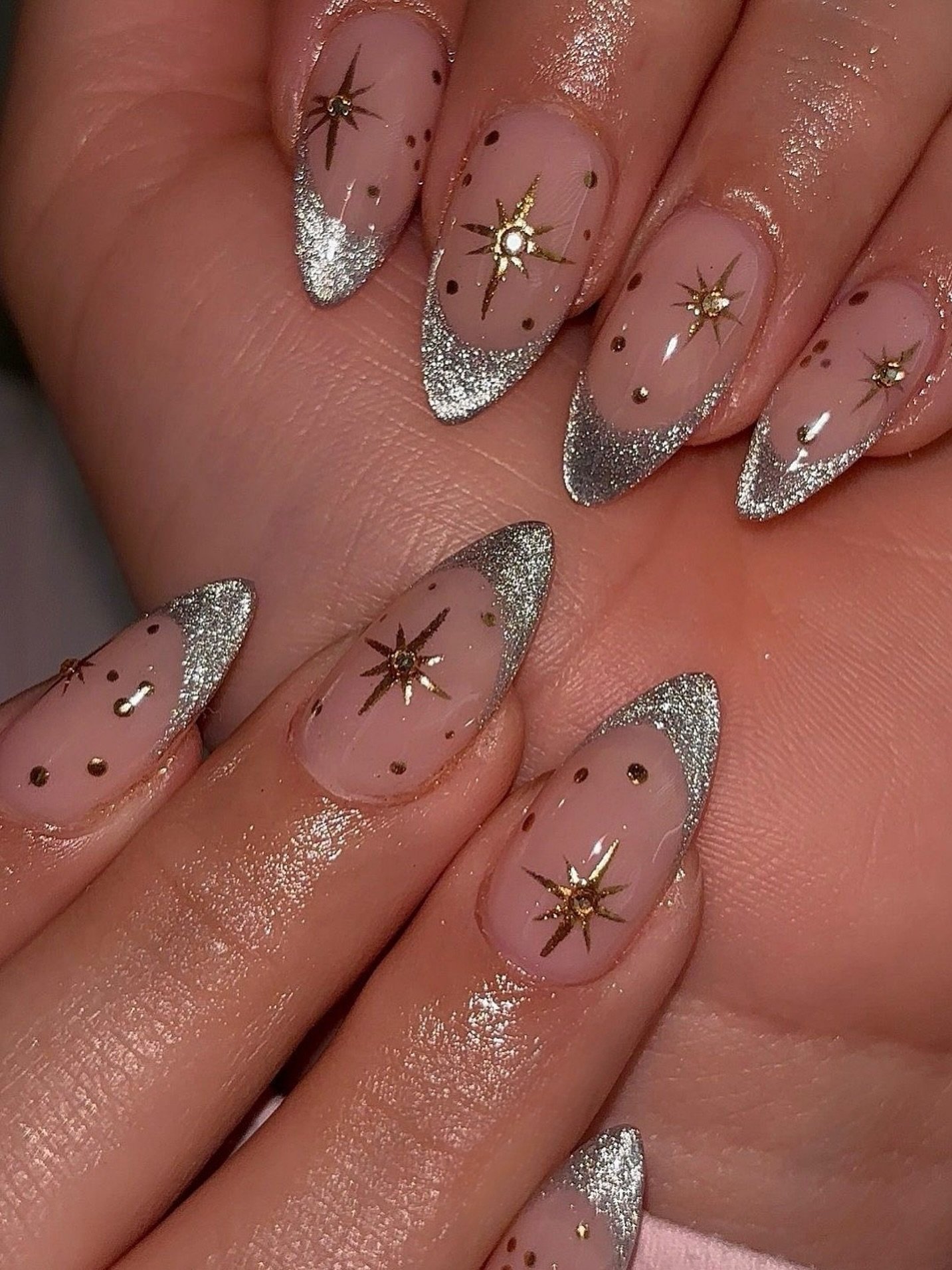 Silver Christmas nails idea 2: Sheer Almond Nails with Silver Glitter Tips and Starbursts