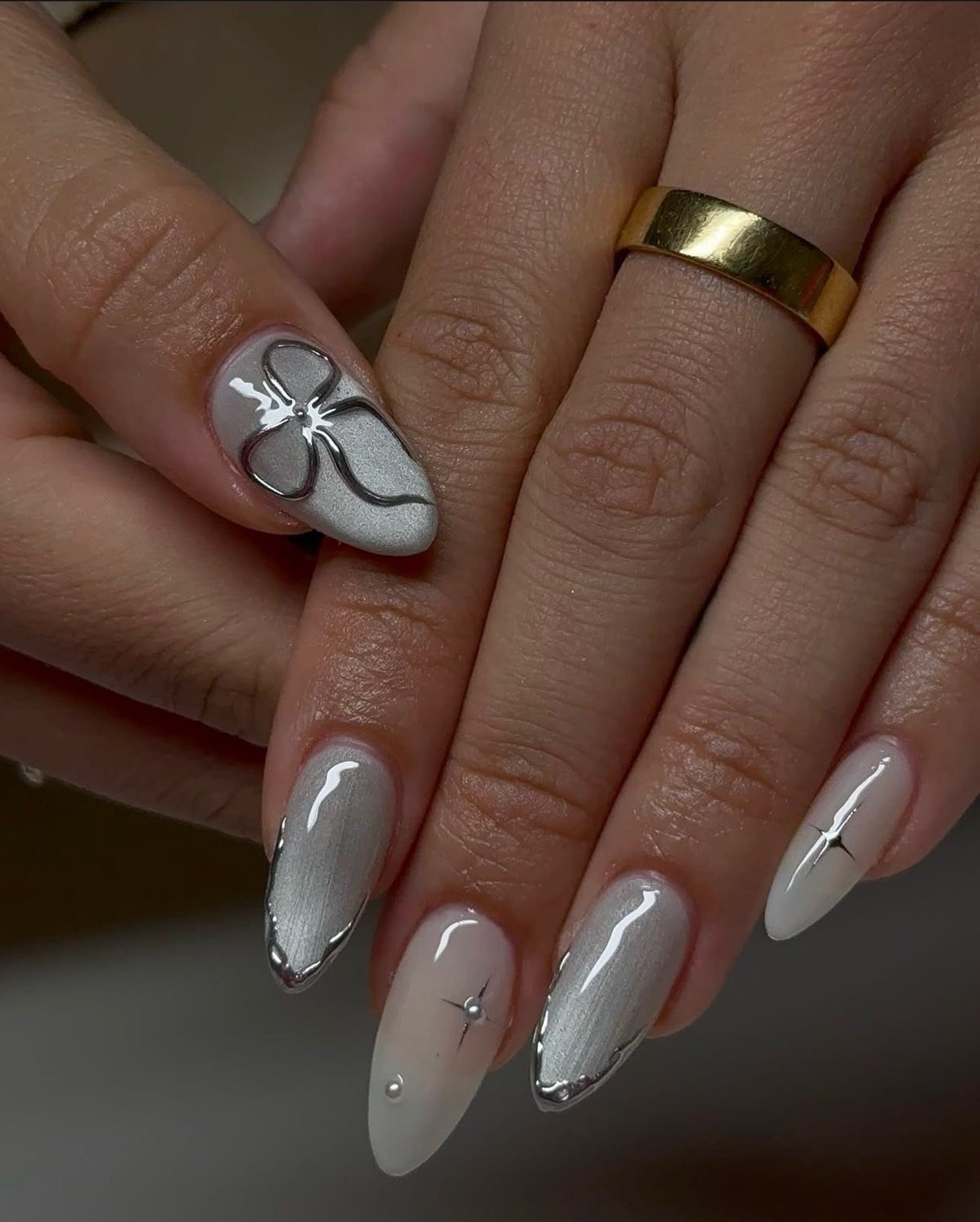 Silver Christmas nails idea 7: Glossy White Almond Nails with Silver Outline Details
