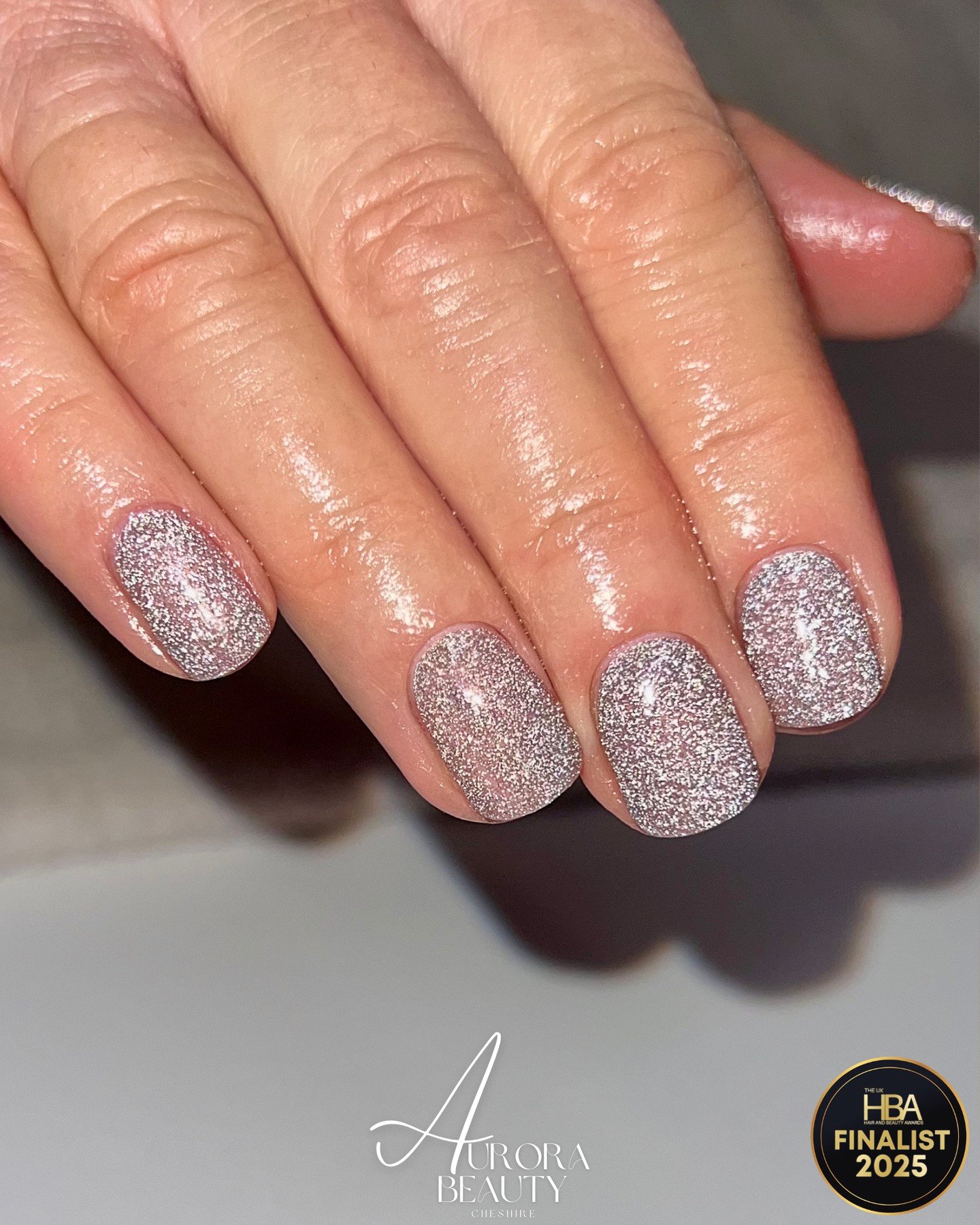 Silver Christmas nails idea 11: Short Rounded Nails Covered in Silver Glitter