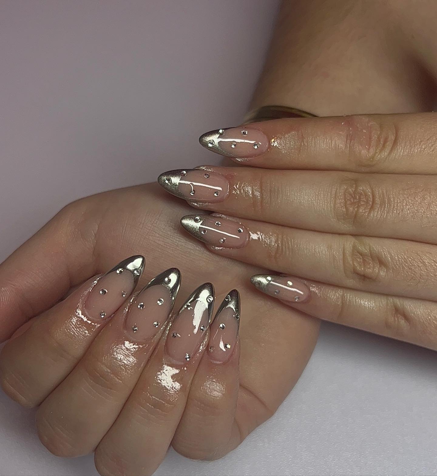 Silver Christmas nails idea 14: Sheer Nude Nails with Silver French Tips and White Accents