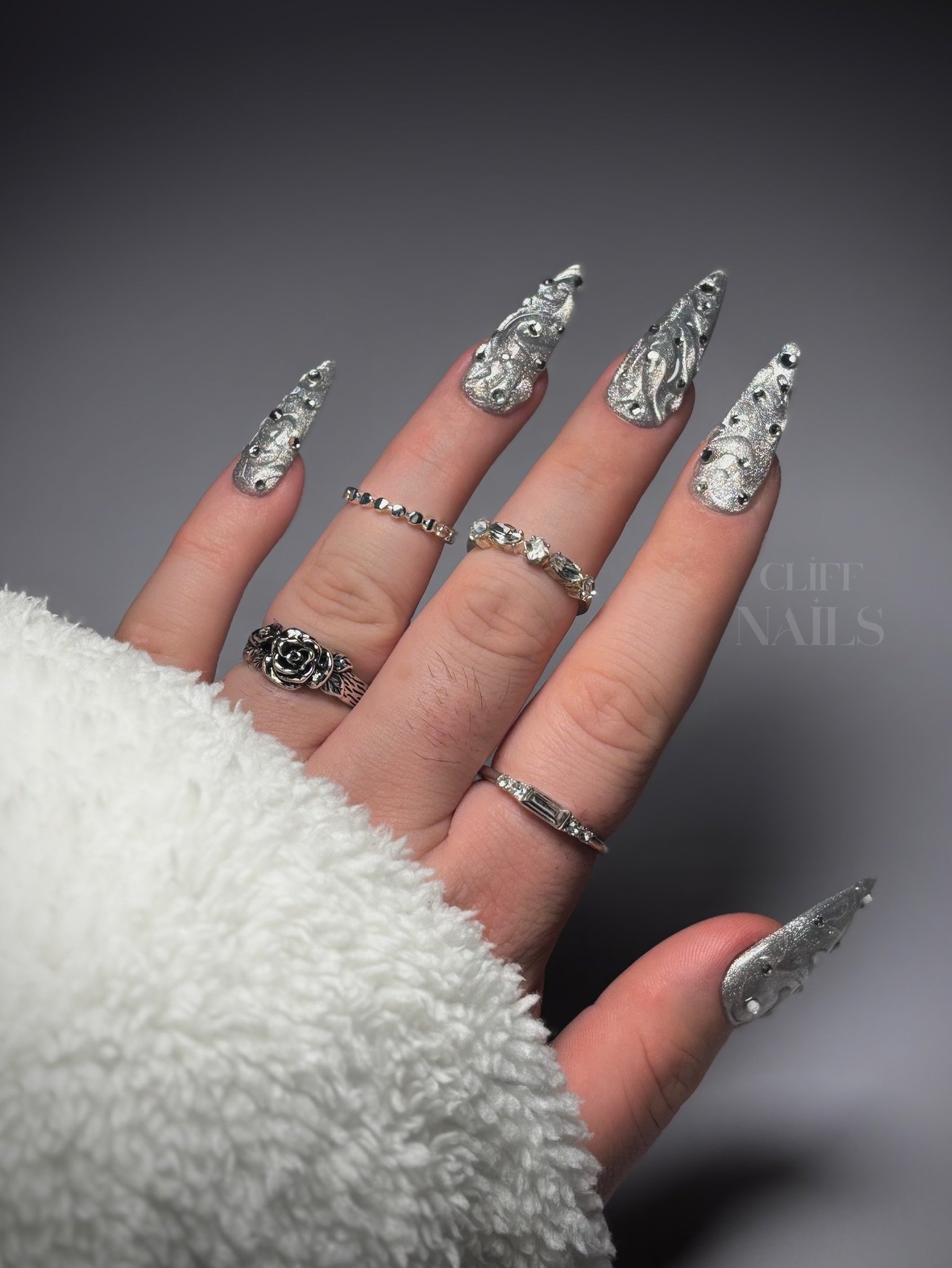 Silver Christmas nails idea 15: Long Stiletto Nails with Silver Glitter and Winter Details