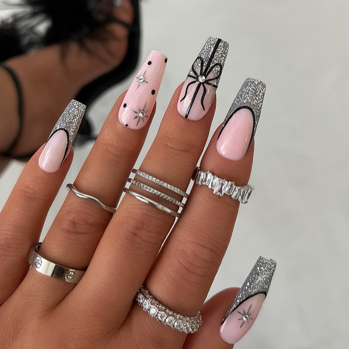 Silver Christmas nails idea 16: Pink and Silver Nails with Bows and Fine Line Art