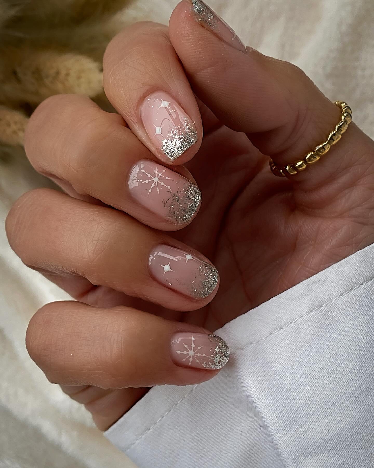 Silver Christmas nails idea 18: Soft Pink Glitter Nails with Fine White Holiday Details