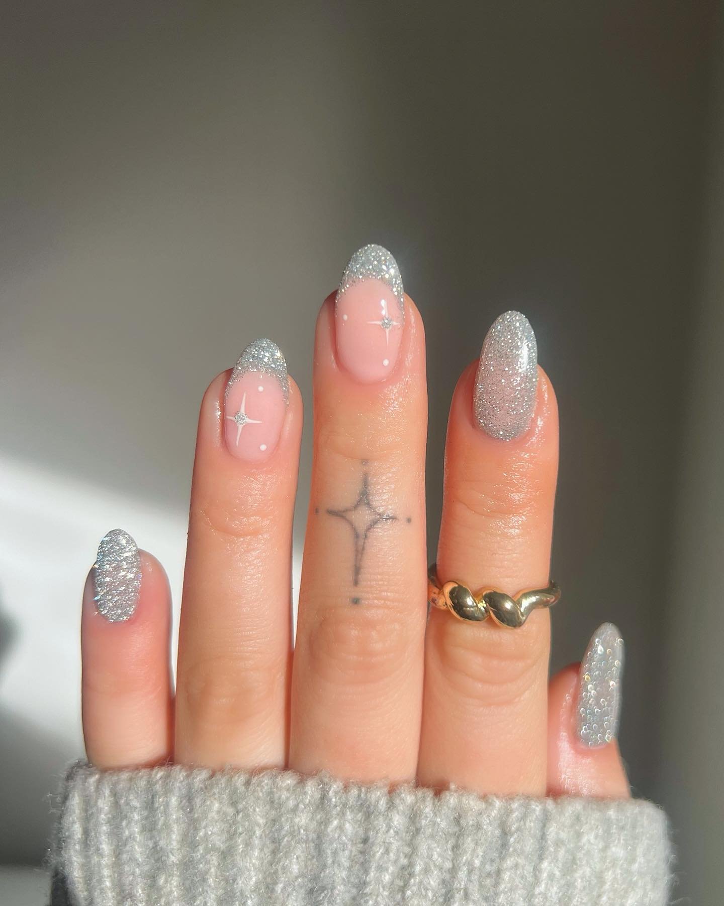 Silver Christmas nails idea 19: Pink and Silver Glitter Nails with Minimal Star Accents