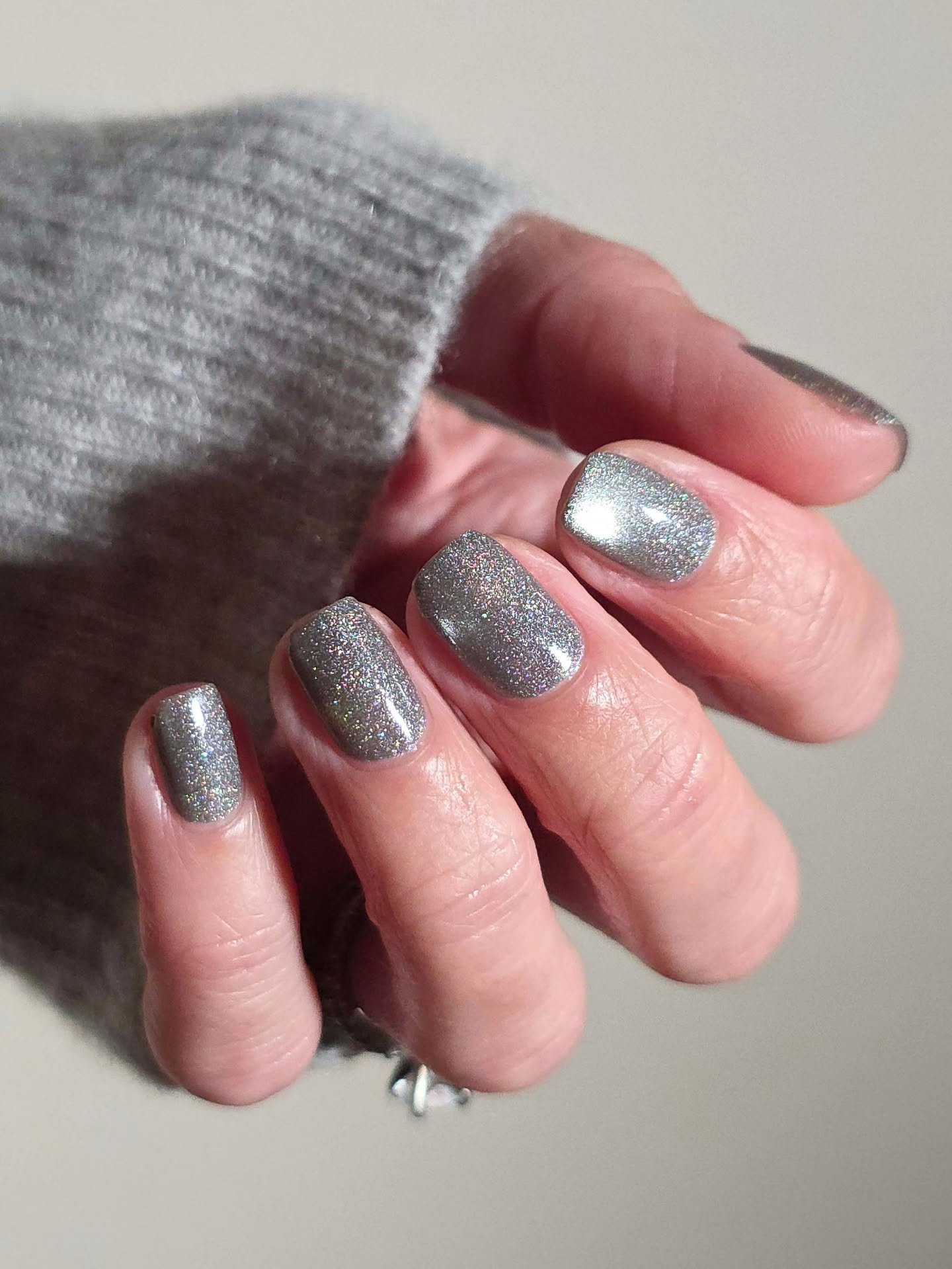 Silver Christmas nails idea 24: Short Metallic Silver Nails with a Reflective Finish