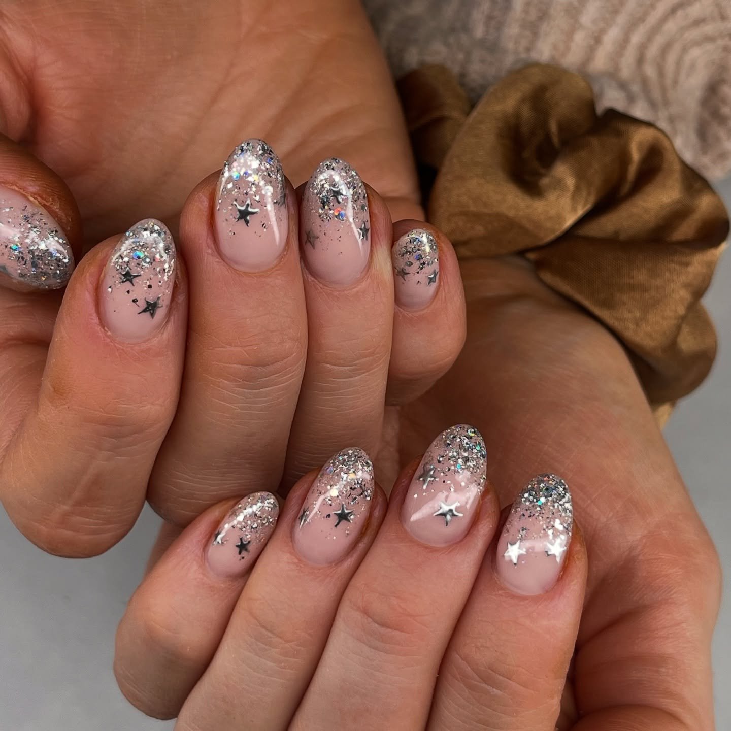 Silver Christmas nails idea 25: Sheer Pink Nails with Silver Glitter, Stars, and Snowy Details