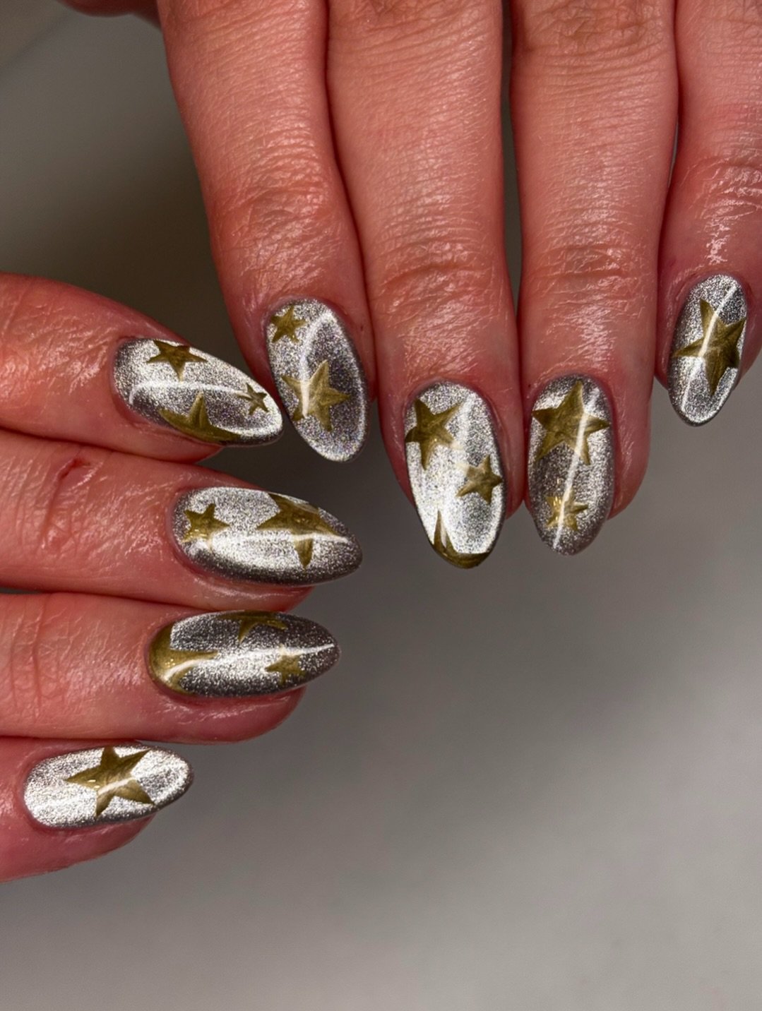 Silver Christmas nails idea 28: White and Silver Almond Nails with Metallic Gold Details