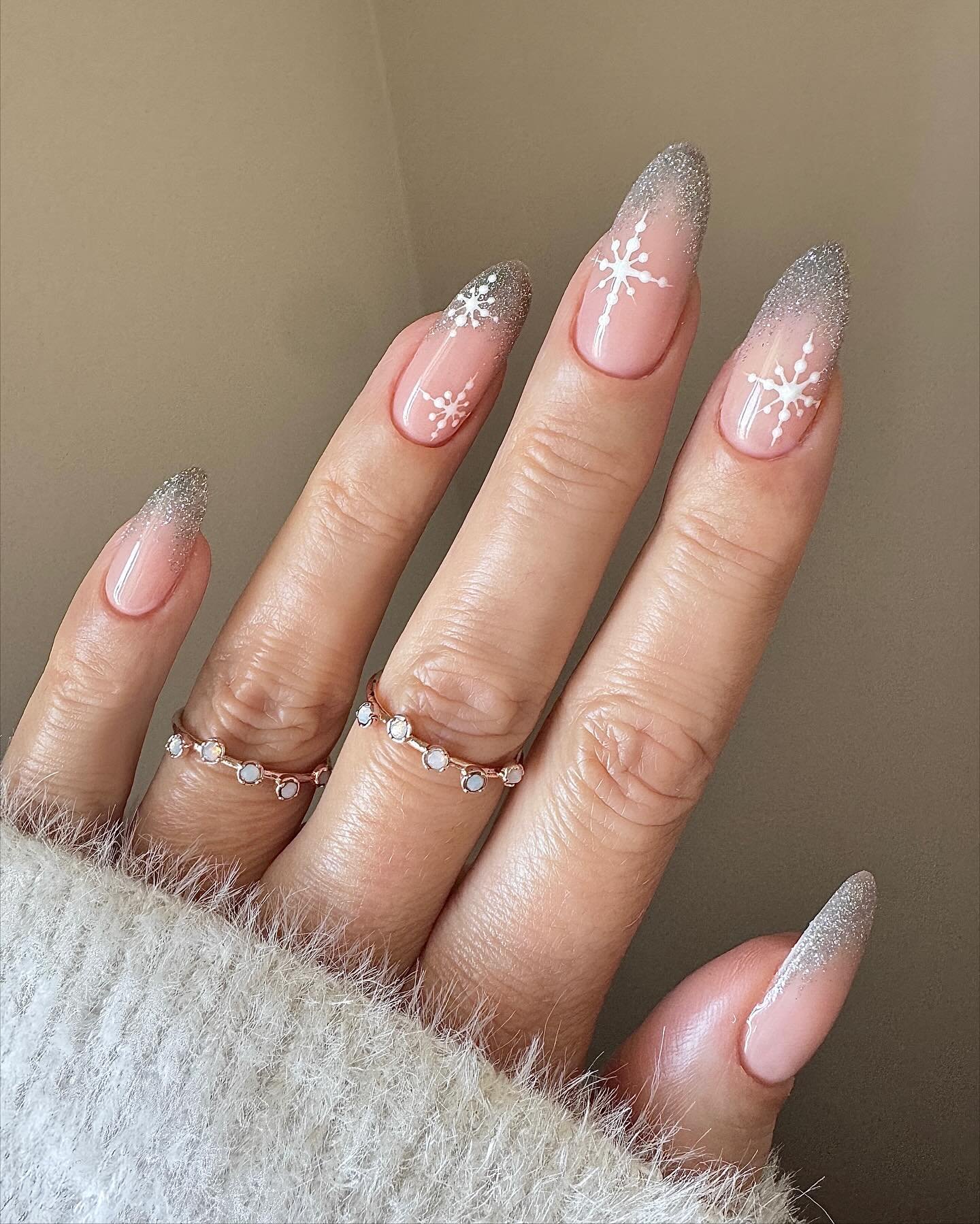 Silver Christmas nails idea 35: Pink Almond Nails with Silver Glitter and White Star Details