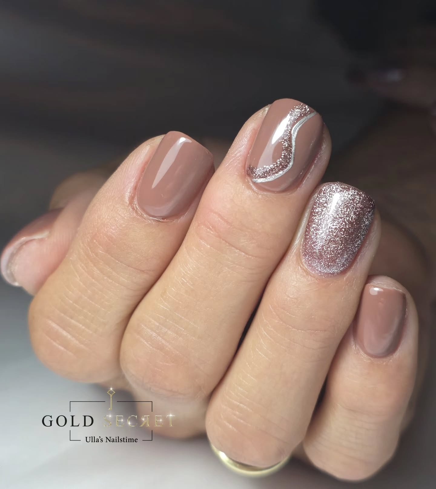 Taupe Nails with a Glittering Accent and Curved Detail