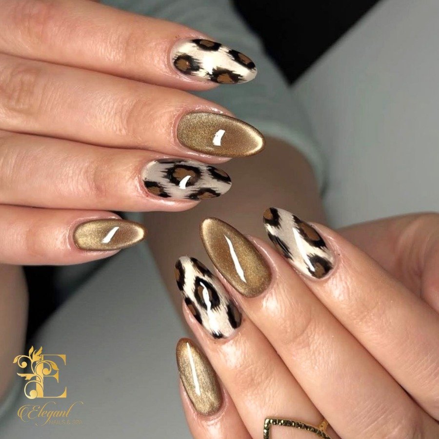 Medium almond nails pair reflective gold nails with black-and-white abstract accent nails.