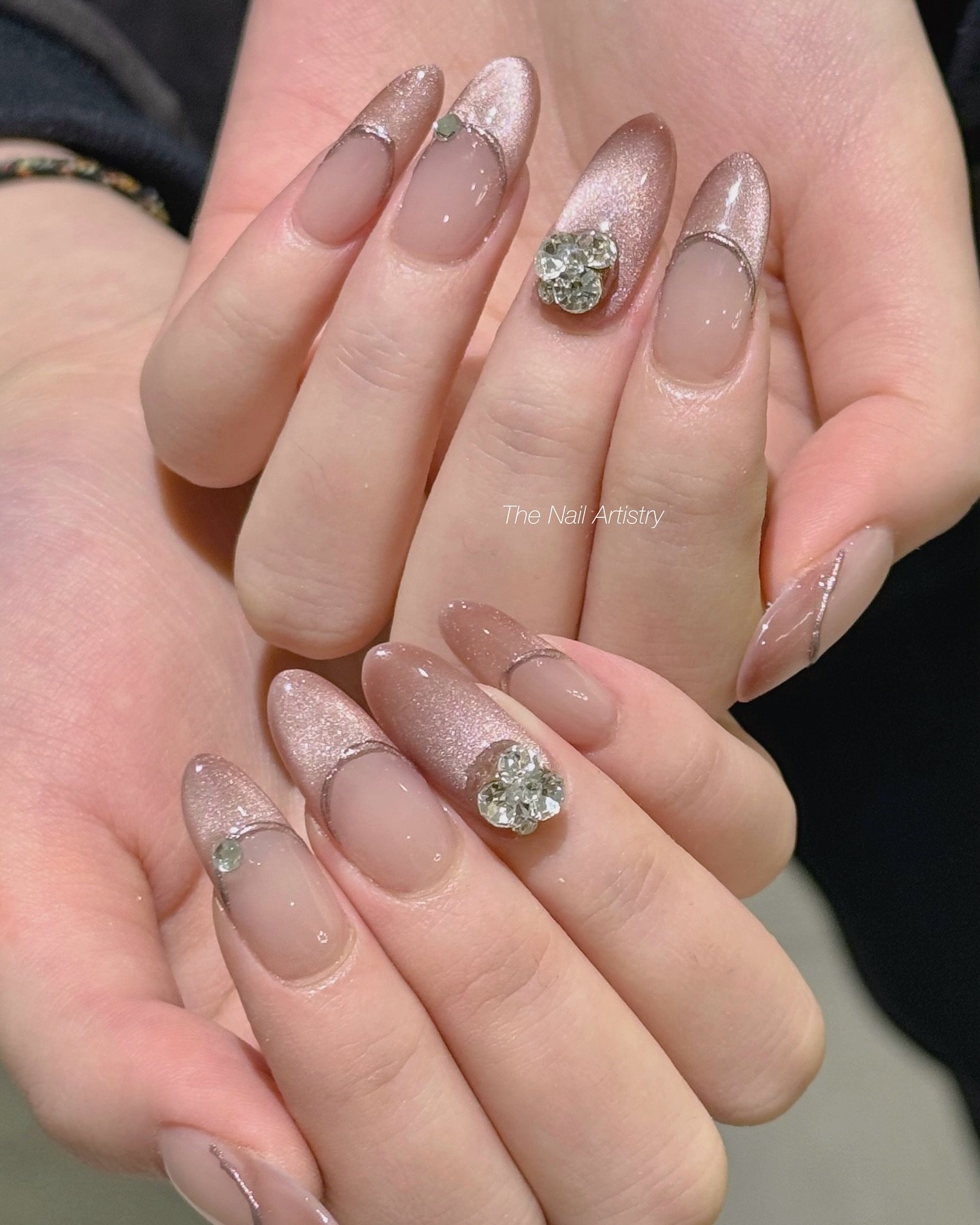 Long almond nails feature deep red glossy color with darker accent sections that create a high-contrast finish.