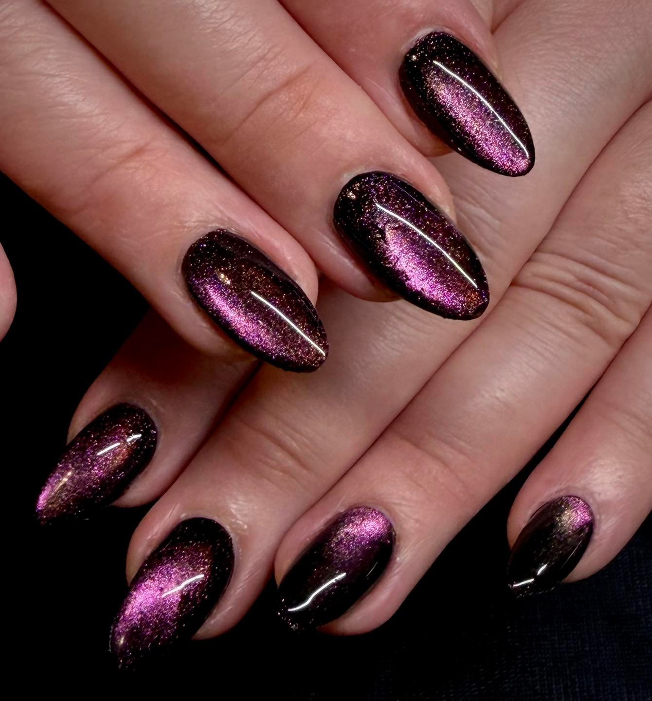 Long almond nails combine a silvery taupe center with dark edging for a reflective framed effect.