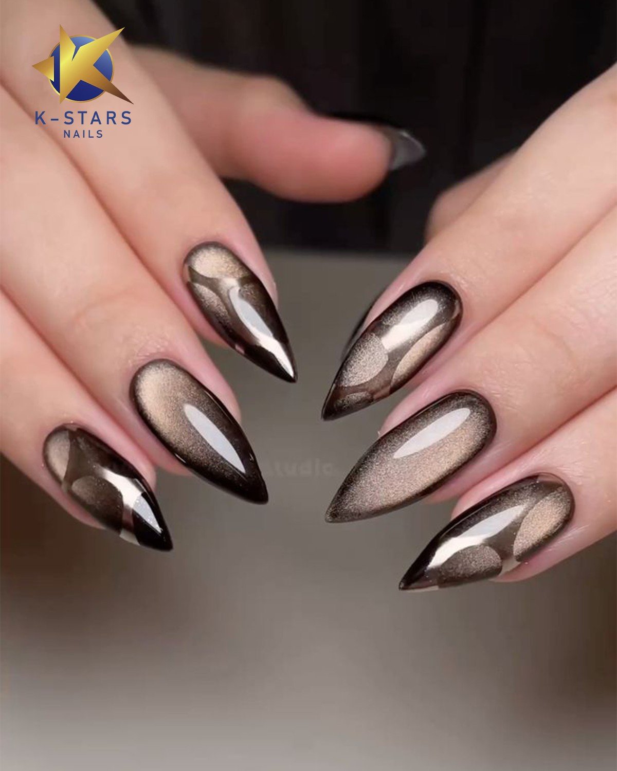 Medium almond nails show a muted taupe-brown base with a soft reflective shimmer concentrated through the center.