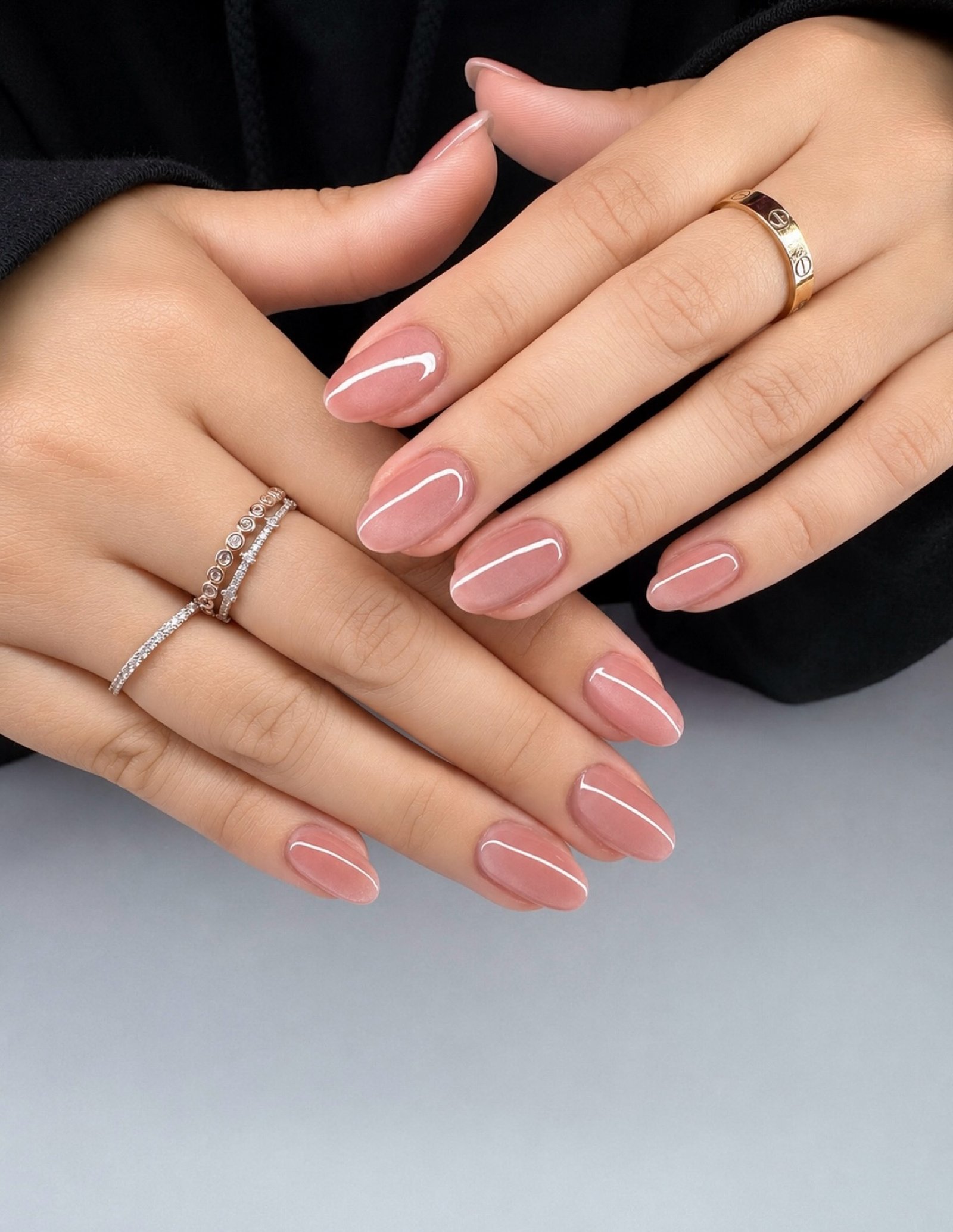 Long almond nails alternate olive green and brown-taupe shades with glossy reflective finishes.