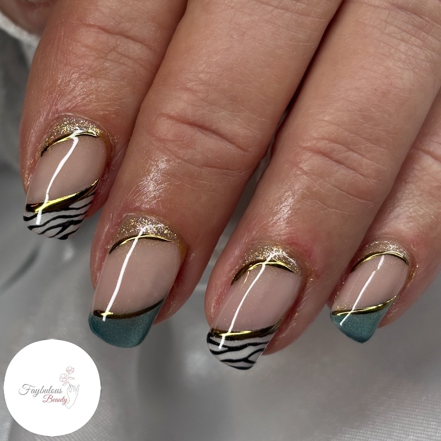 Long almond nails mix lavender, taupe, and soft pink tones with metallic gold and dark reflective accents.