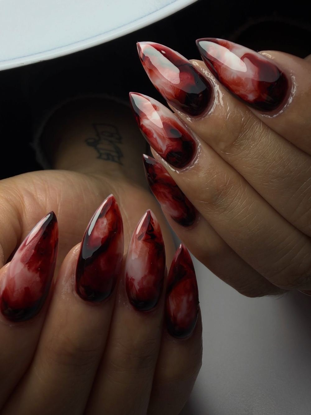 Long Stiletto Nails with Deep Red Marbled Details