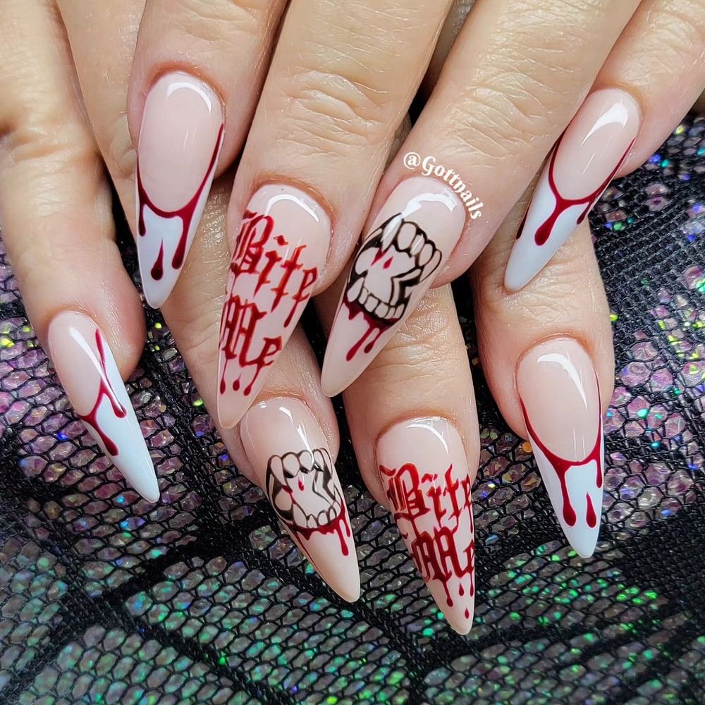 White Almond Nails with Red Drips and Graphic Lettering