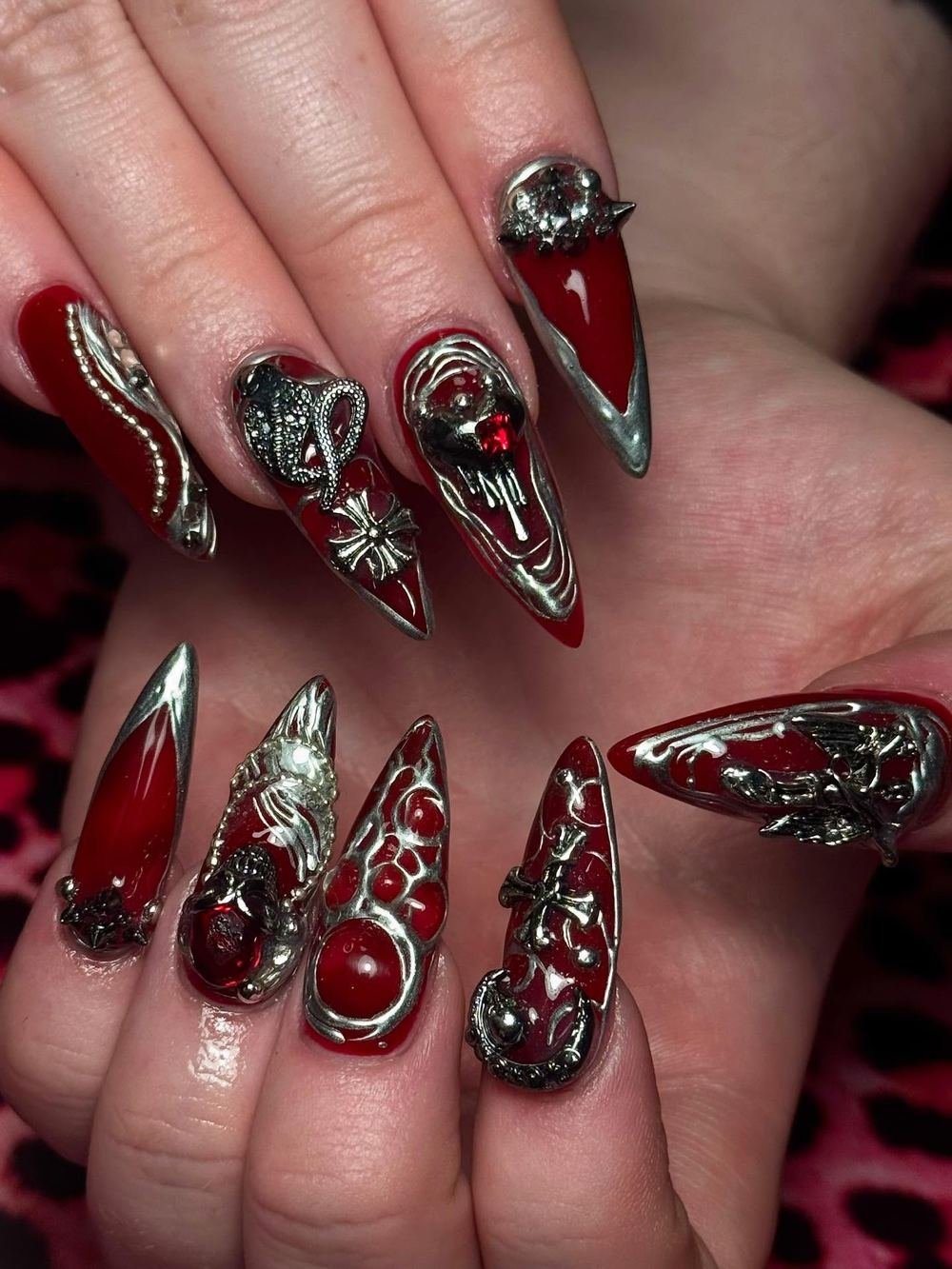 Ornate Red and Black Stiletto Nails with Silver Details