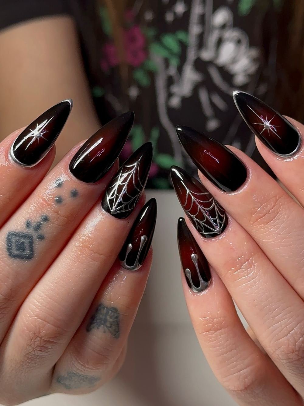 Black Almond Nails with Red Accents and Fine Line Art