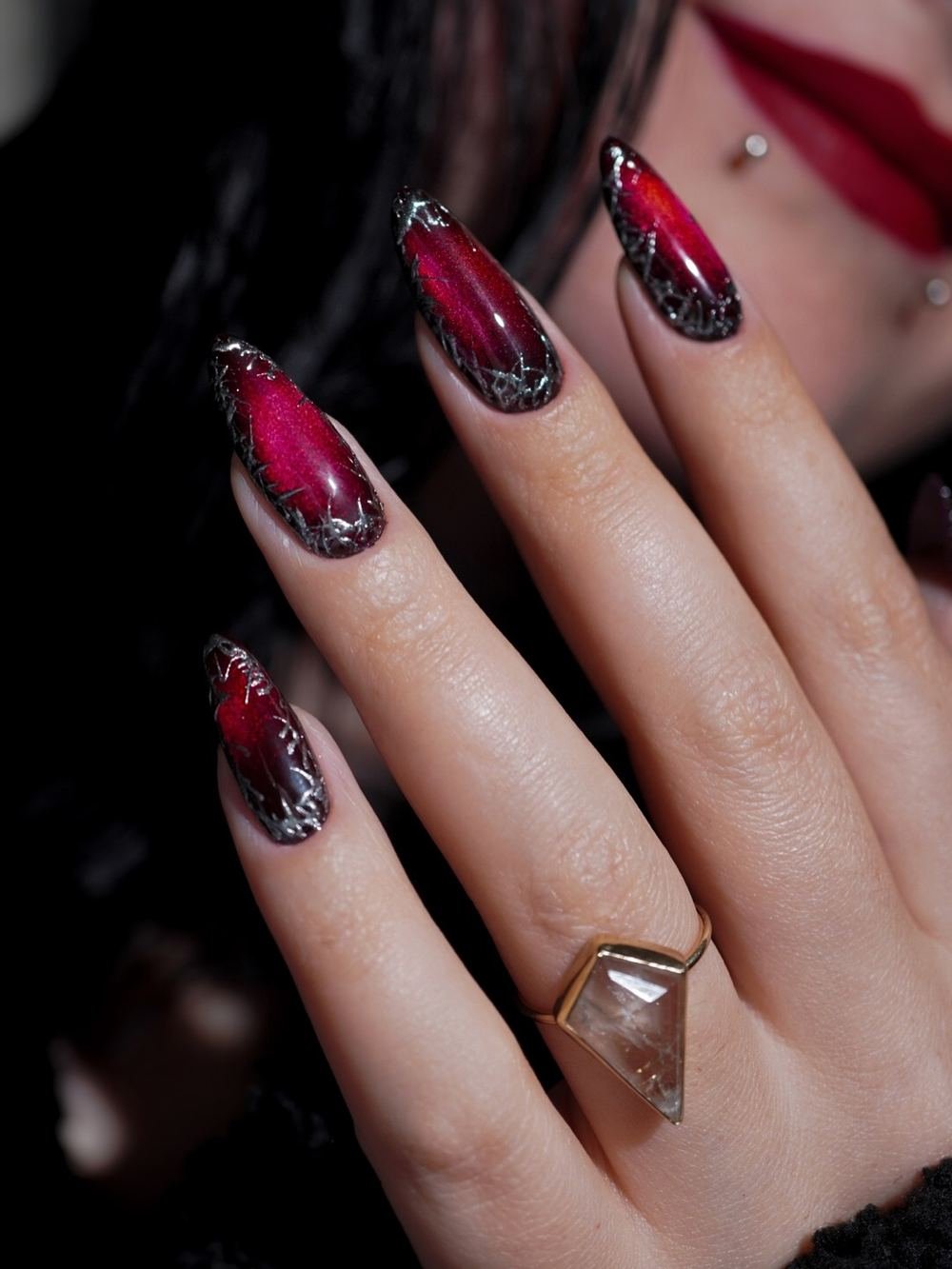 Deep Red Almond Nails with Silver and Black Embellishment