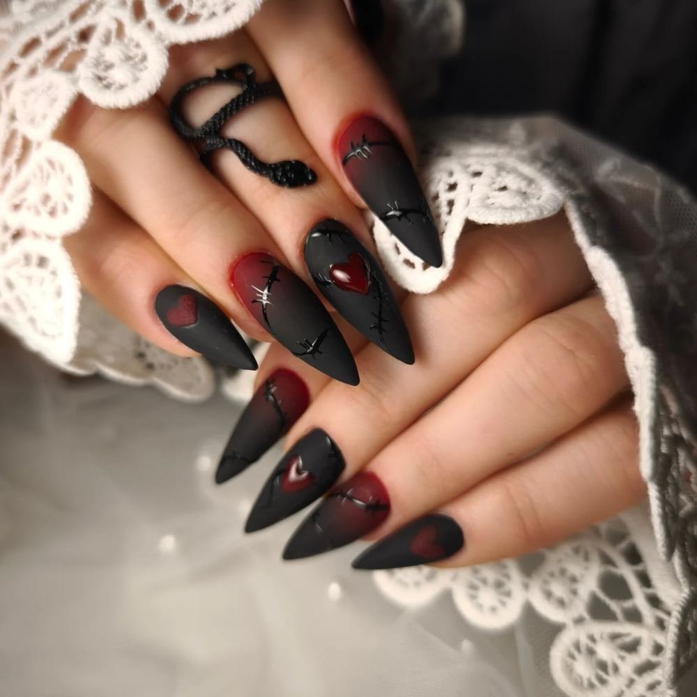 Matte Black Stiletto Nails with Red Accents