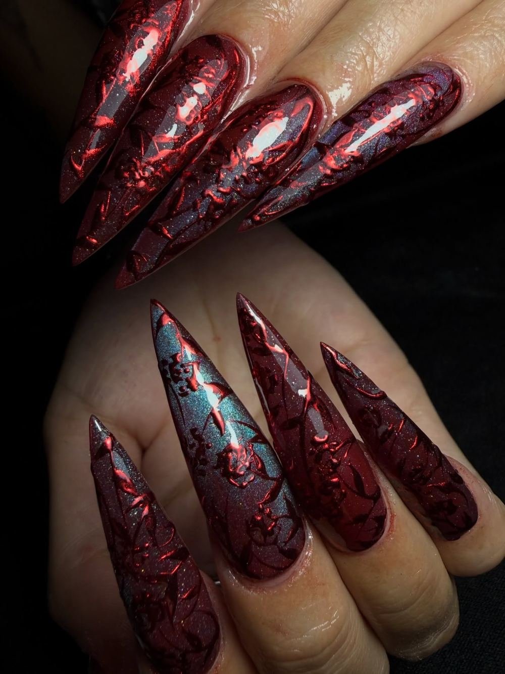 Deep Red Stiletto Nails with Textured Blue-Silver Details