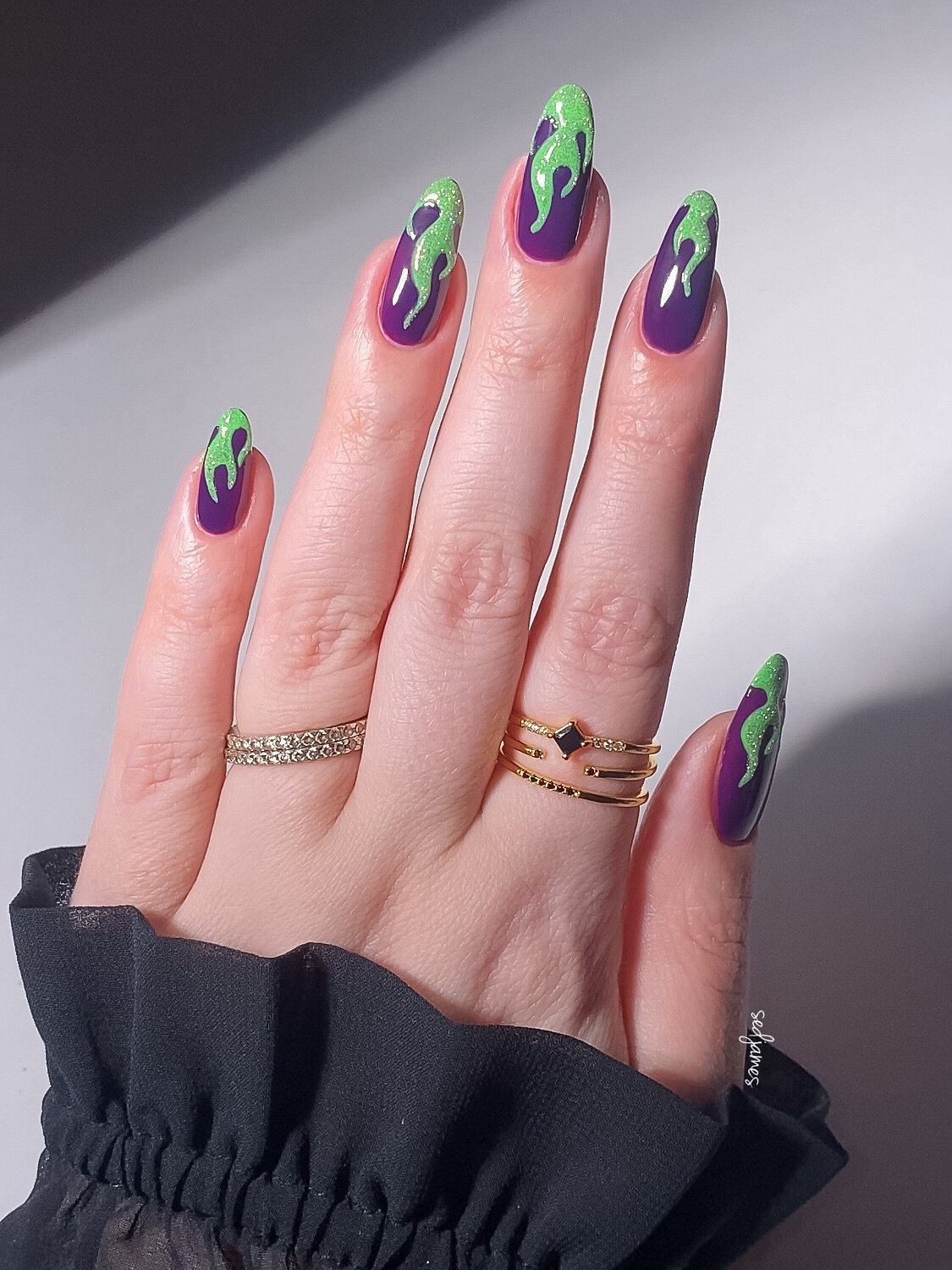 Purple and Green Stiletto Nails with Curved Graphic Details