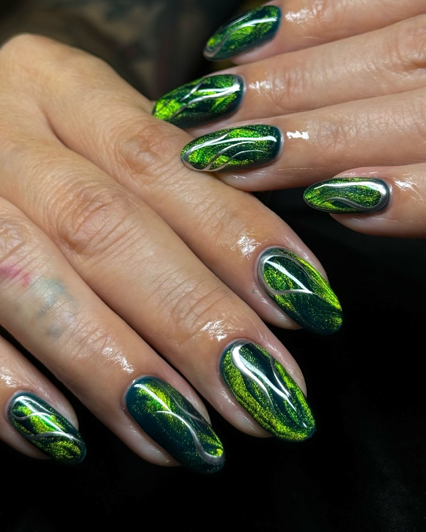 Dark Green Almond Nails with Bright Green Swirl Accents