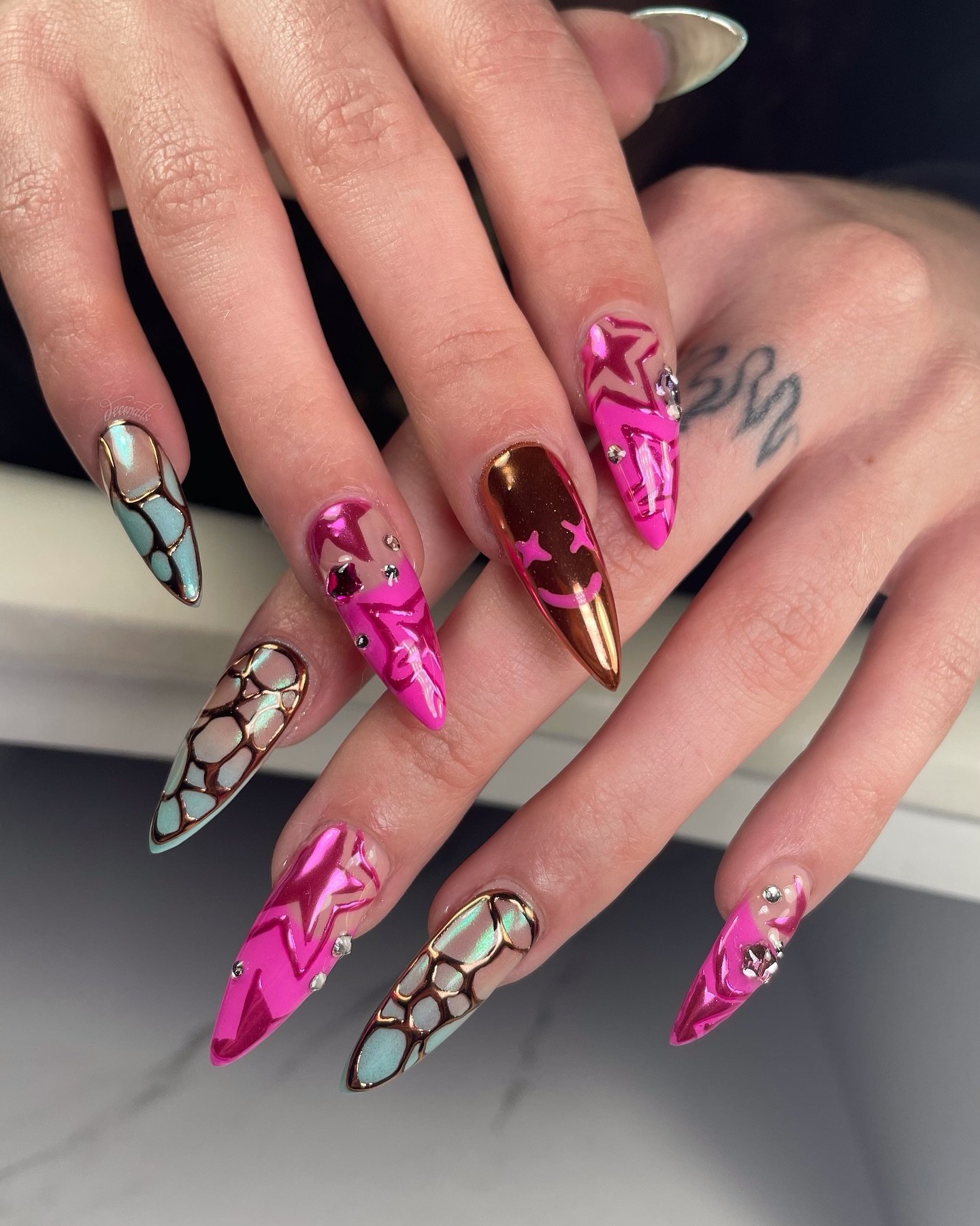 Pink Long Stiletto Nails with Black, White, and Metallic Art