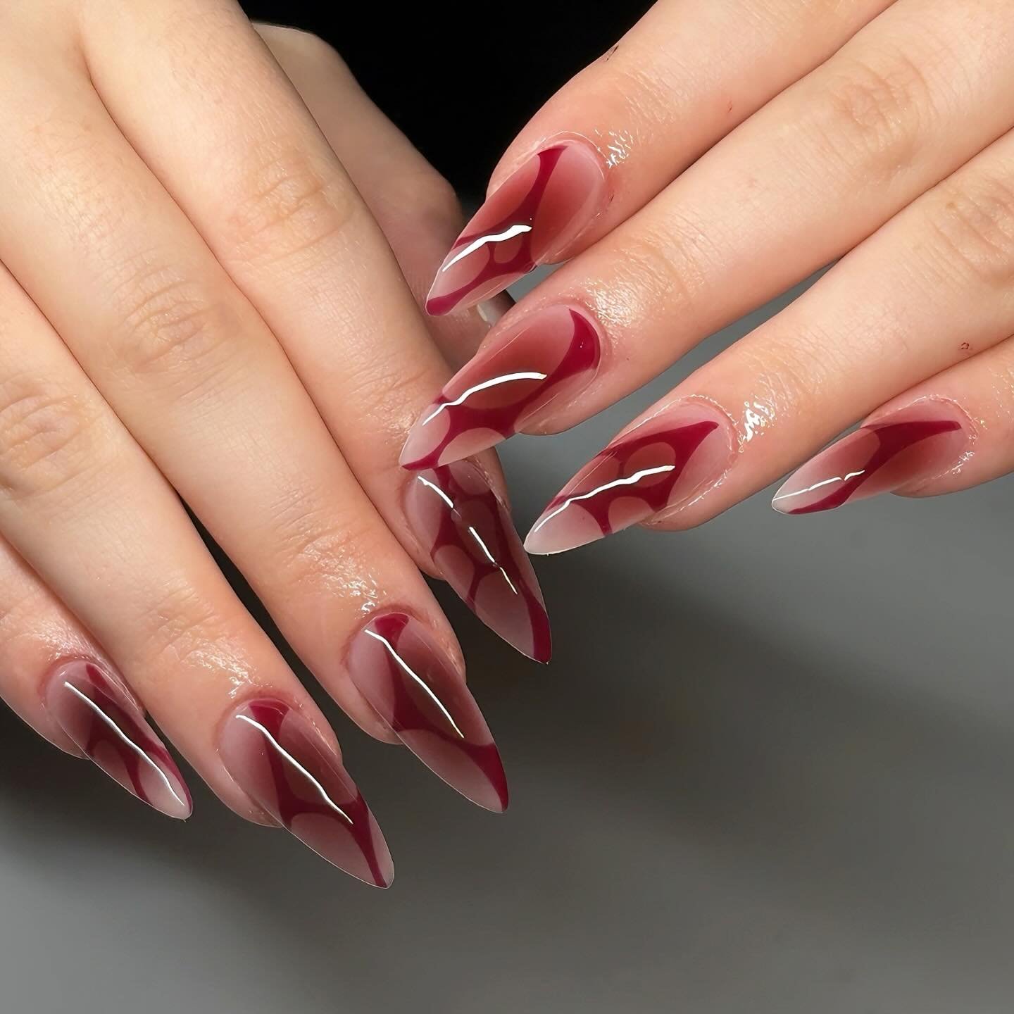 Long Burgundy Stiletto Nails with Dark Layered Accents