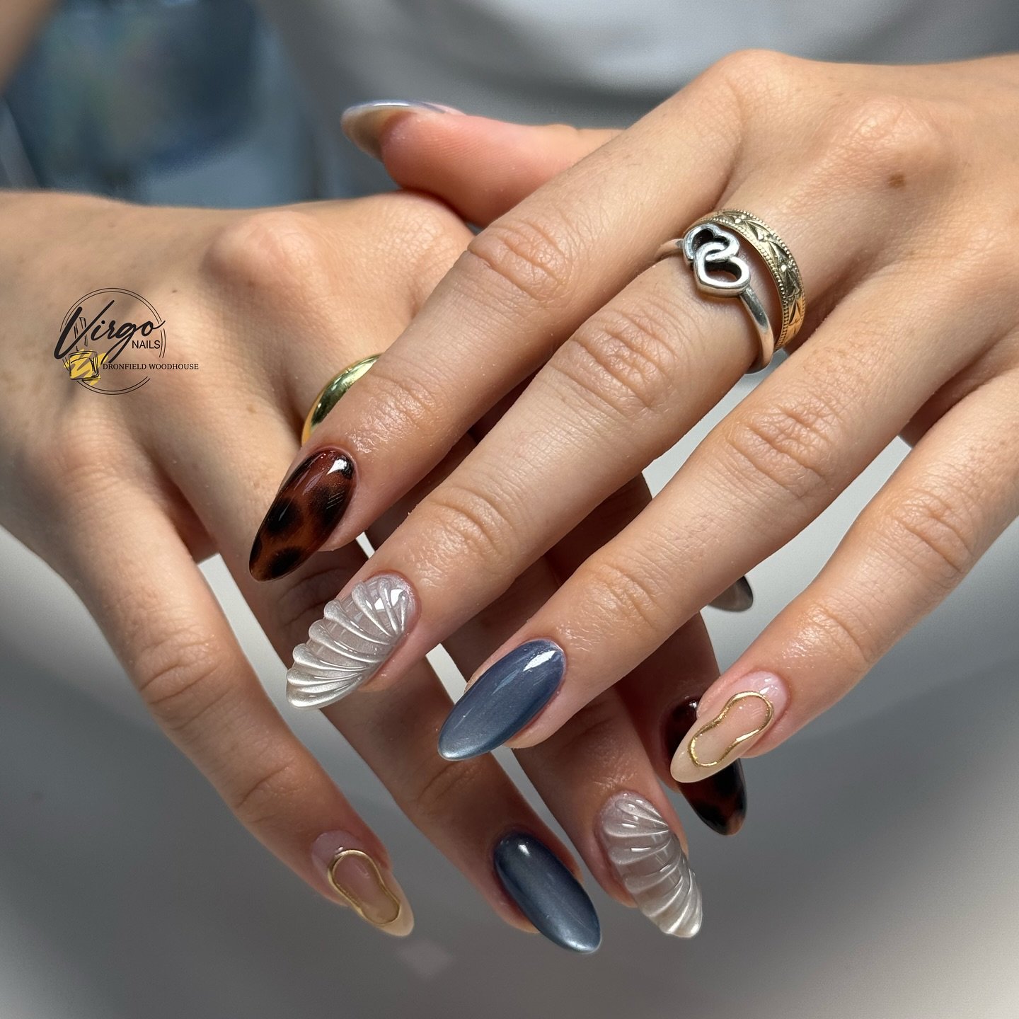 Mixed Brown, Blue, Nude, and Clear Almond Nails