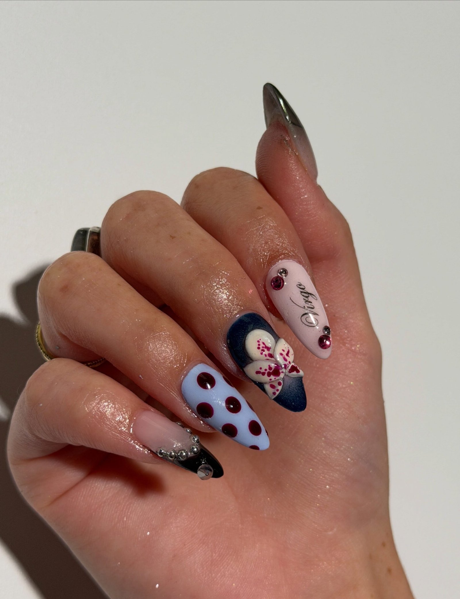 Pastel Almond Nails with Cow Spots and Dark Floral Accents