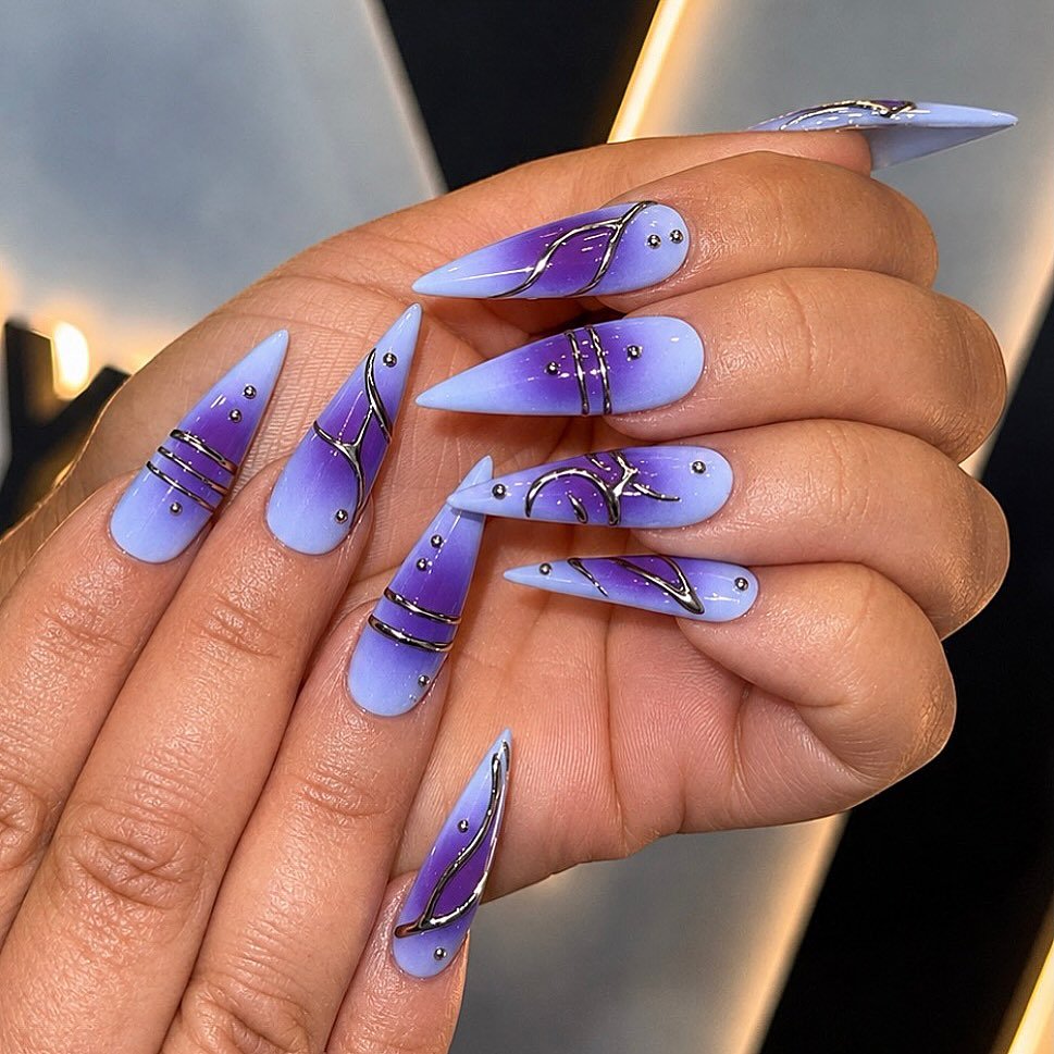 Lavender Stiletto Nails with White Swirls and Gold Accents