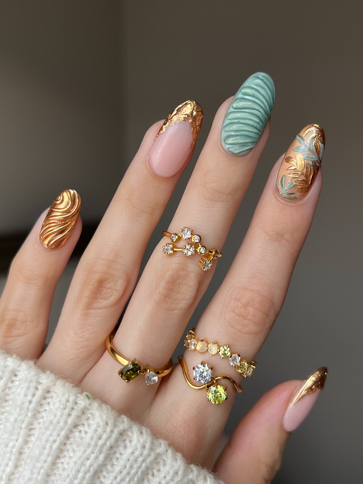Olive Green Nails with Red and Gold Decorative Details