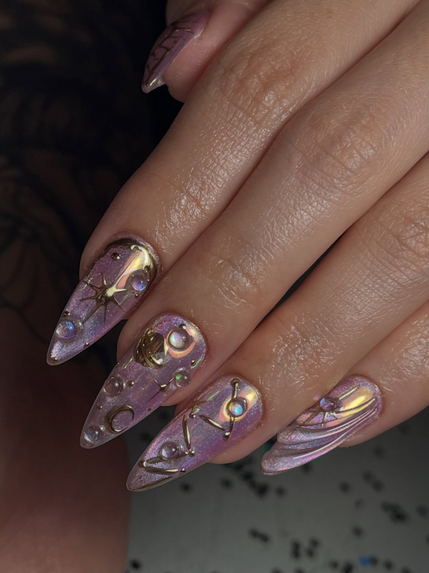 Pink Constellation Almond Nails with Black and Gold Details