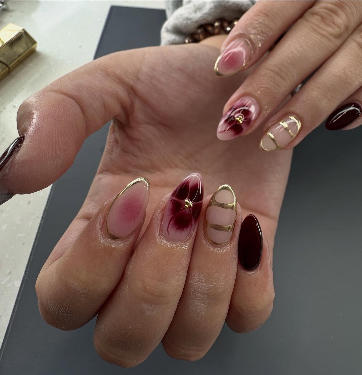 Wine and Nude Almond Nails with Gold Accents