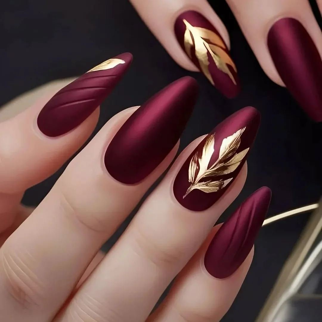 Matte wine nails with gold leaf accents