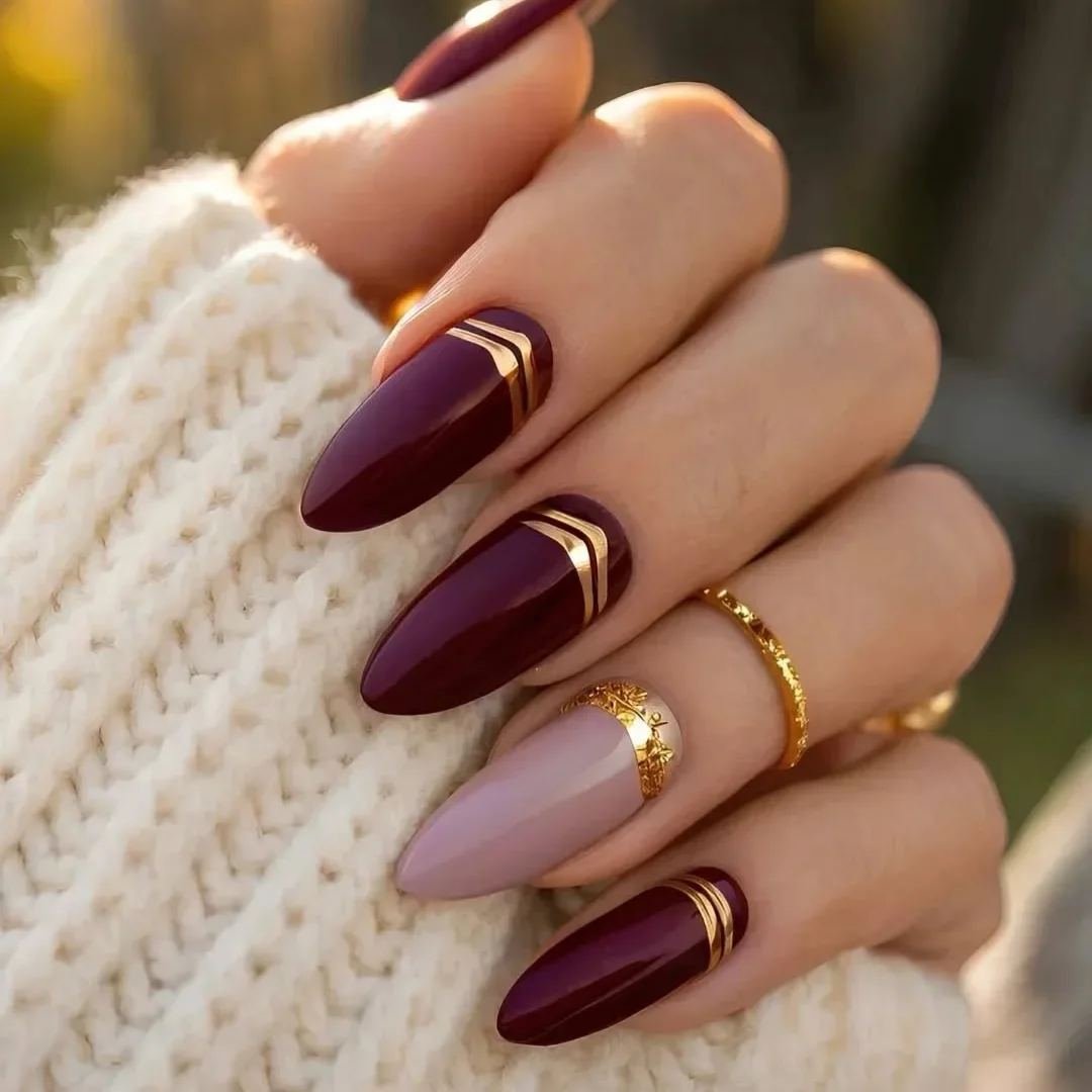Wine and nude nails with gold curves
