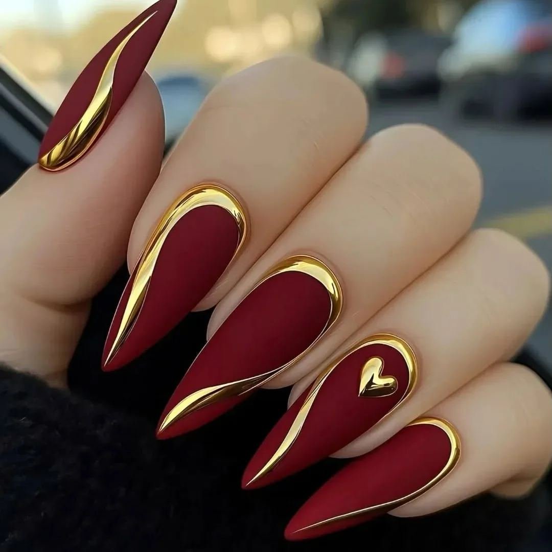 Wine stiletto nails with gold edging